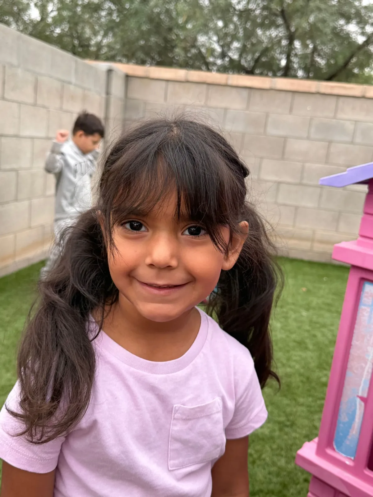 Smiling girl at Angelita's Little Angels child care in Tucson, AZ